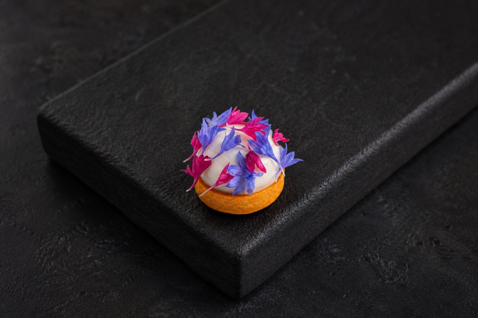 Floral canapé composed with vivid pink and violet petals